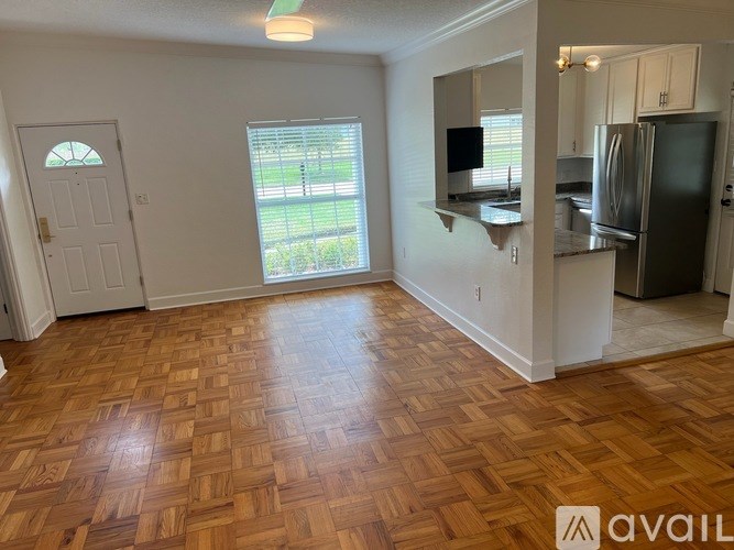A room with wooden flooring and a white door.