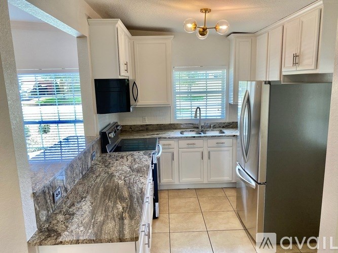 A kitchen with granite countertops and stainless steel appliances.