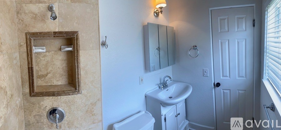 A bathroom with a sink, mirror, and toilet.
