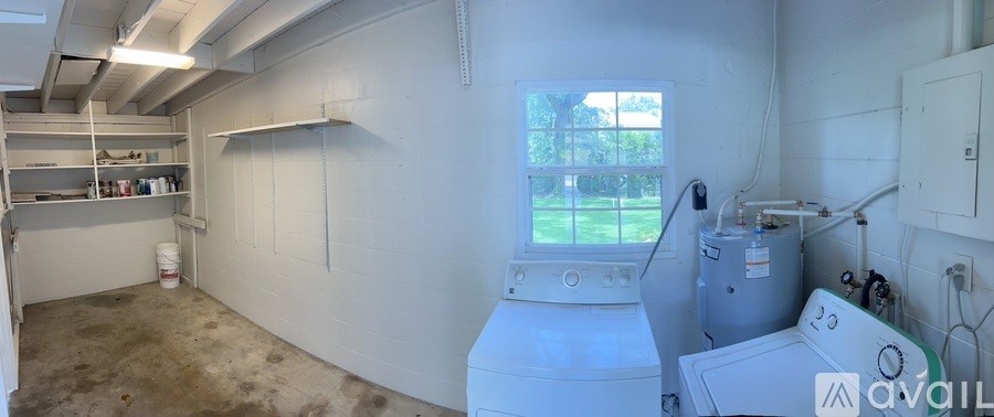 A room with a window, a washing machine, and a dryer.