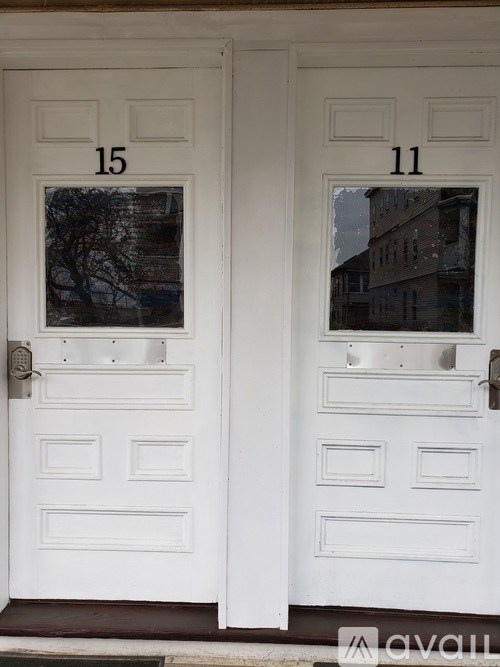 Two white doors with numbers 15 and 11 on them.