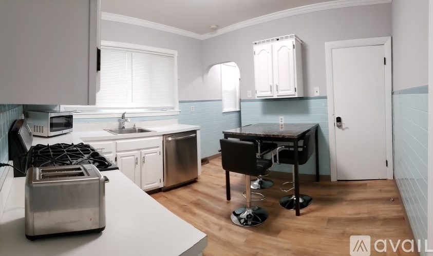 A kitchen with a toaster on the counter.