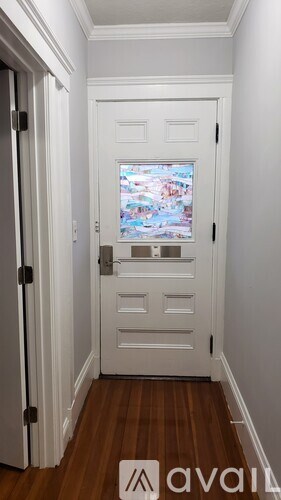 A white door with a glass window in the middle.