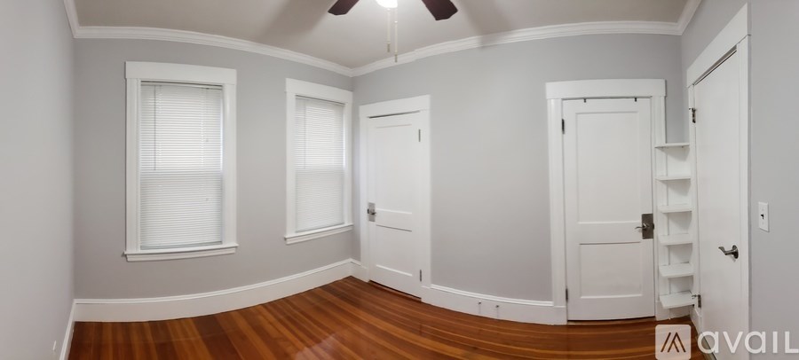 A room with a wooden floor and white walls.