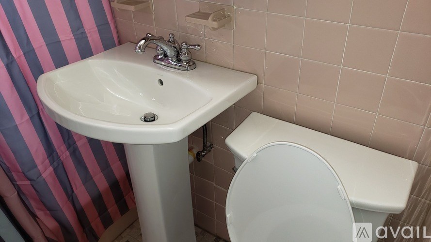 A white sink and toilet in a bathroom.