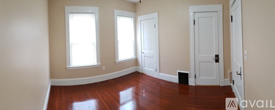 A room with wooden floors and white walls.