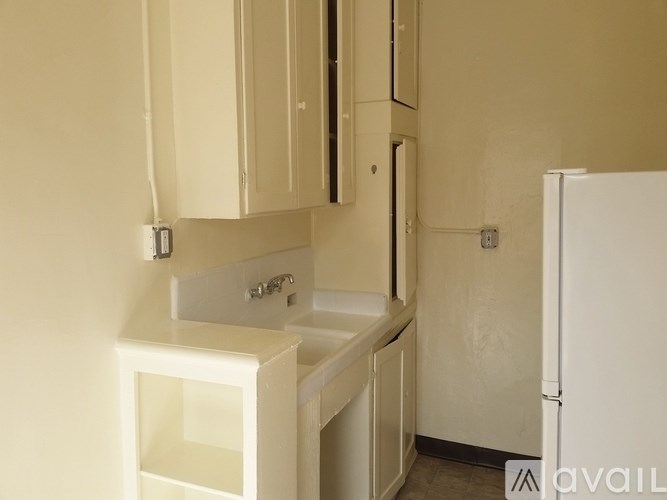 A kitchen with white appliances and cabinets.