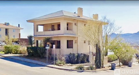 A two-story house with a balcony on the second floor is for sale.