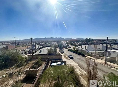 A sunny day in a city with a clear blue sky.