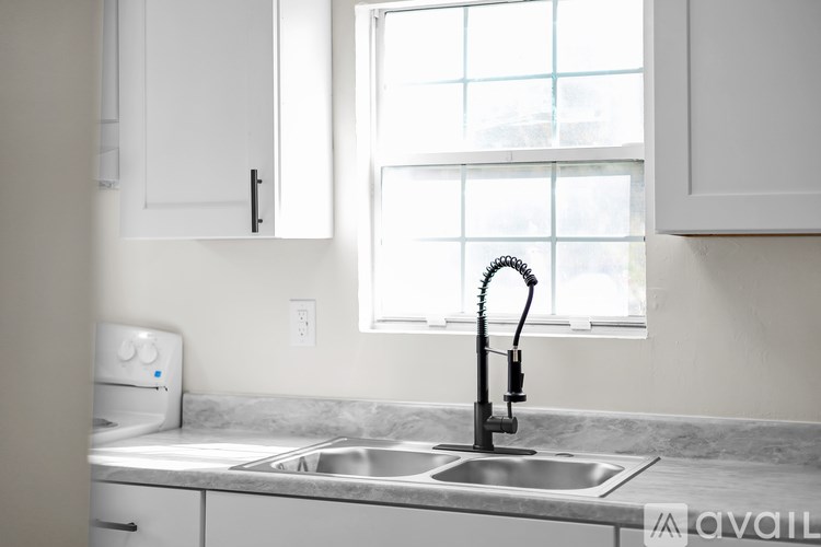 A kitchen with a sink and a window.