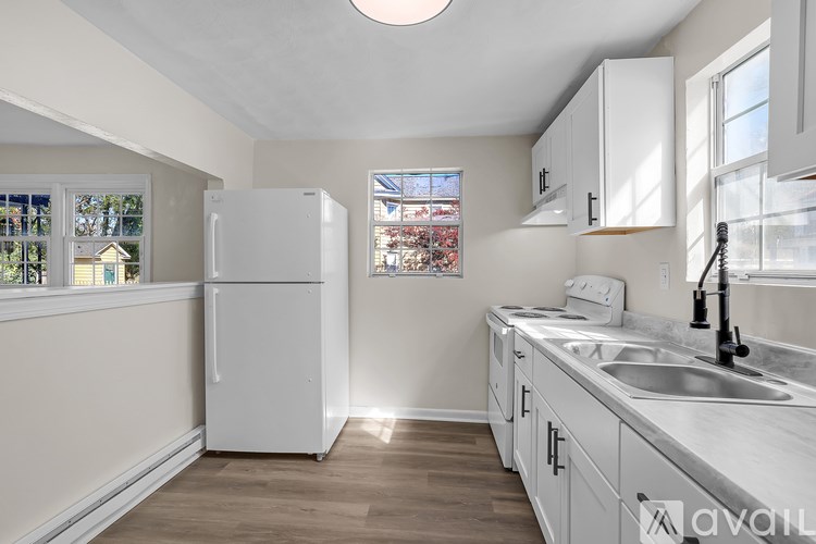 A room with a window and wooden flooring.