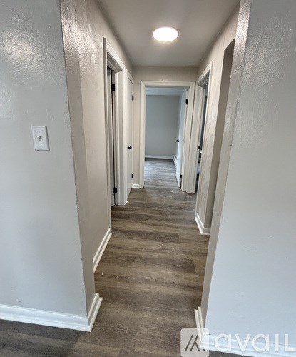 A white kitchen with a stove, oven, and sink.