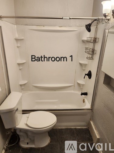 A bathroom with a toilet, sink and bathtub.