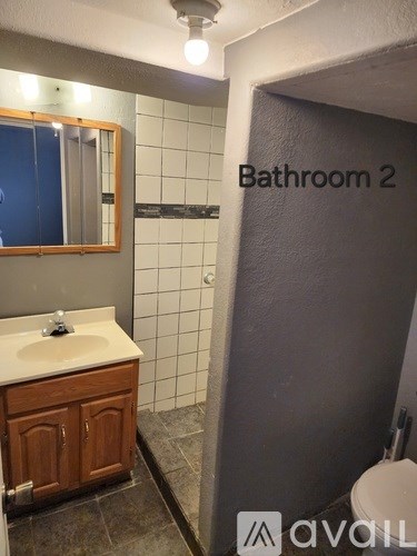 A bathroom with a sink, mirror, and toilet.
