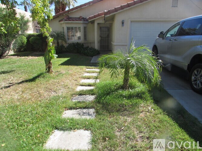 A house with a white garage door and a silver car parked in front.