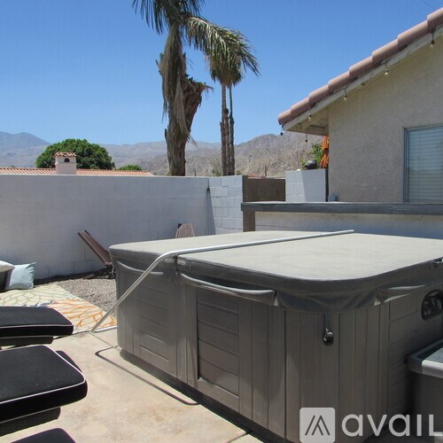 A hot tub is in the middle of a patio.