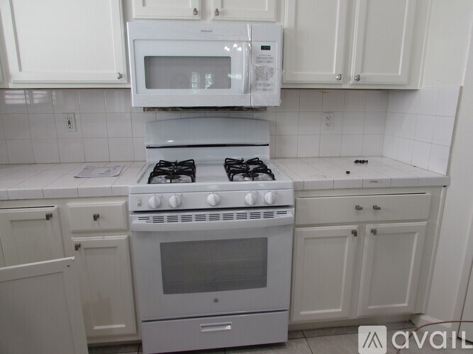 A white kitchen with a stove and oven.