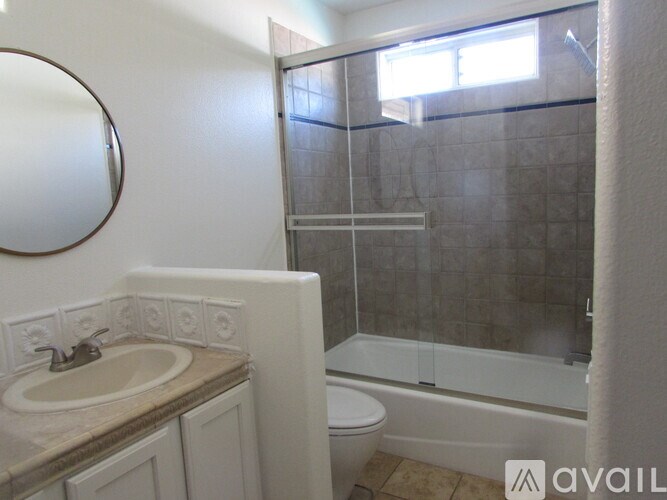 A bathroom with a sink, toilet, and bathtub.