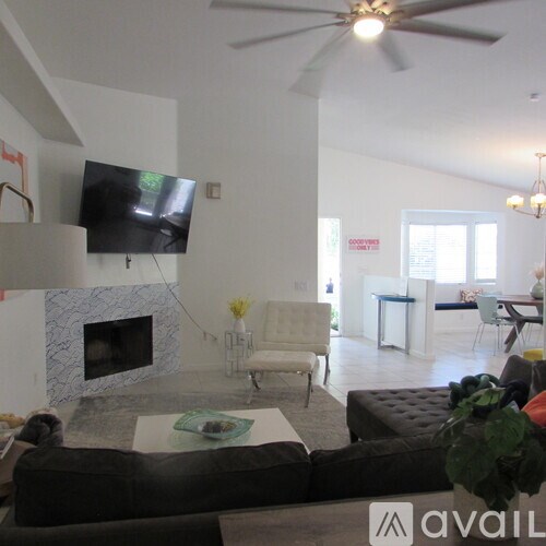 A living room with a television, a fireplace, and a couch.