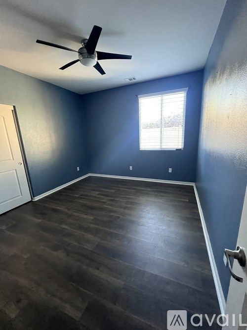 A room with a ceiling fan and a window.