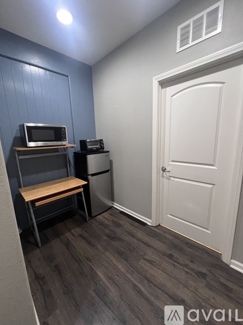 A kitchen area with a microwave, oven, and refrigerator.