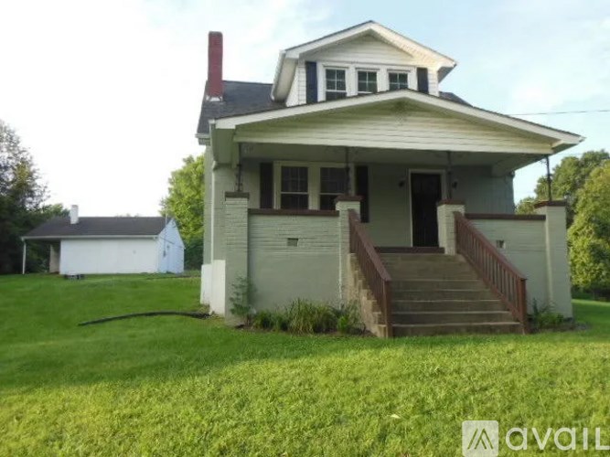 A white house with a grey front porch.