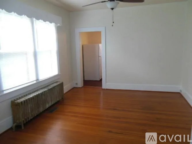 A room with wooden floors and a ceiling fan.