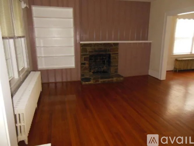 A room with a fireplace and wooden floors.