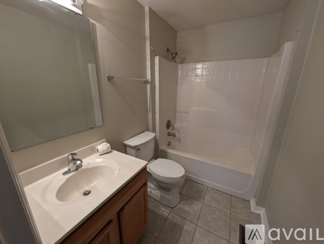 A bathroom with a toilet, sink, and bathtub.