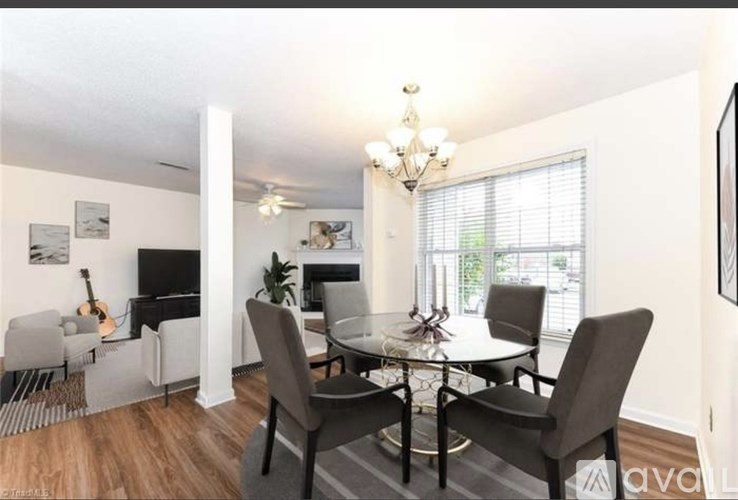 A dining room with a glass table and chairs.
