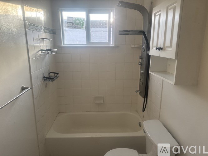 A bathroom with a tub, toilet, and sink.