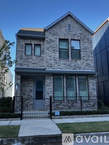 A two-story house with a black door and windows.