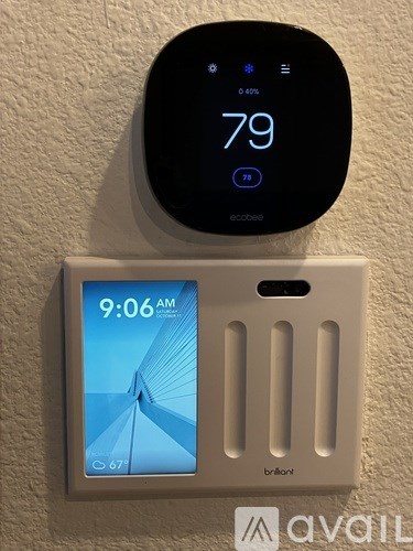 A wall-mounted thermostat and clock display a temperature of 79 degrees.