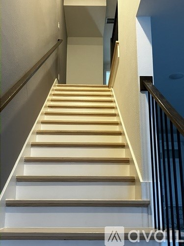 A staircase with wooden steps and a metal railing.