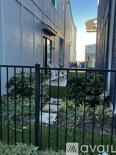 A black metal fence in front of a white building.