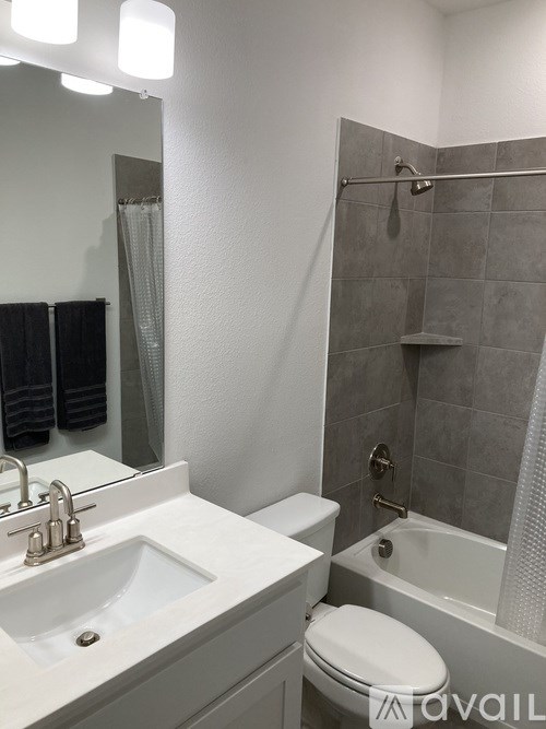A bathroom with a white sink, toilet, and bathtub.