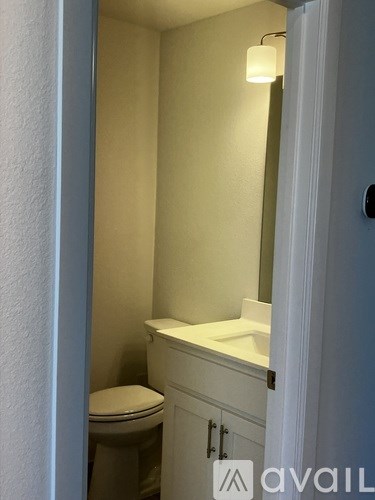 A white toilet is in a small bathroom.