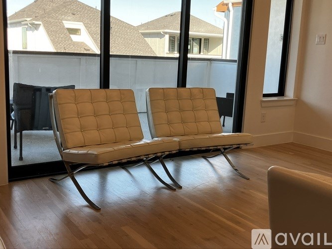 Two chairs are placed in front of a window.