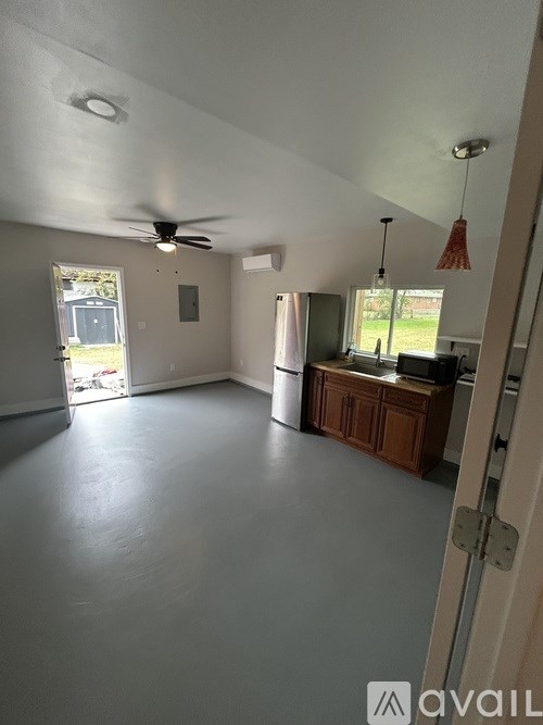 A room with a ceiling fan and a window.