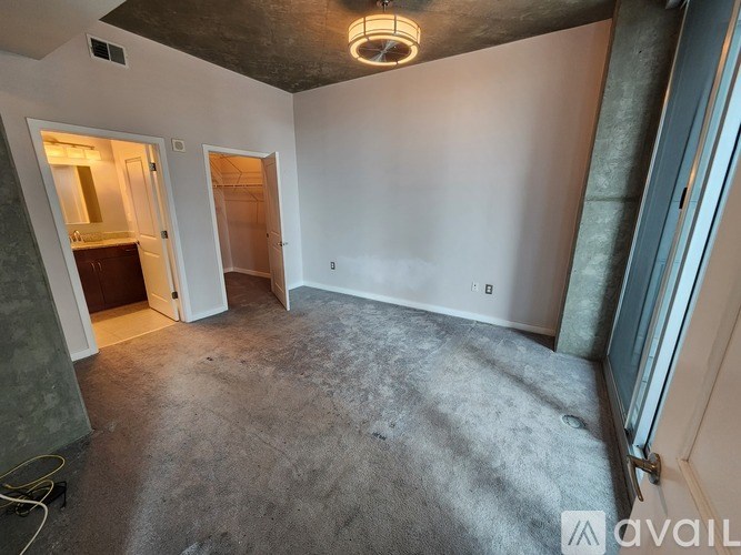 A room with a concrete floor and a ceiling light is available for rent.