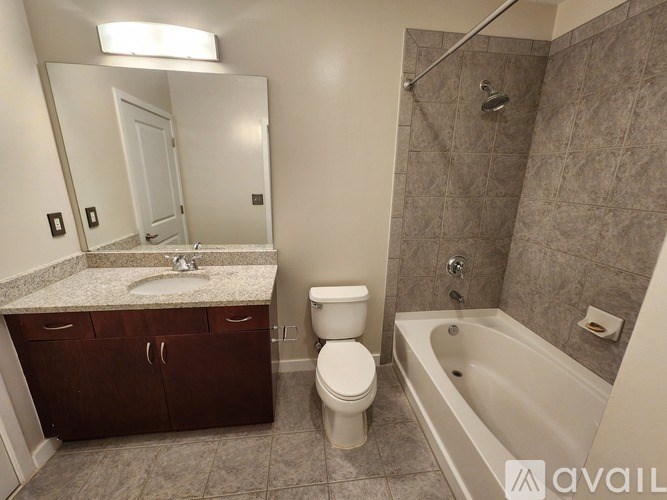 A bathroom with a toilet, sink, and bathtub.