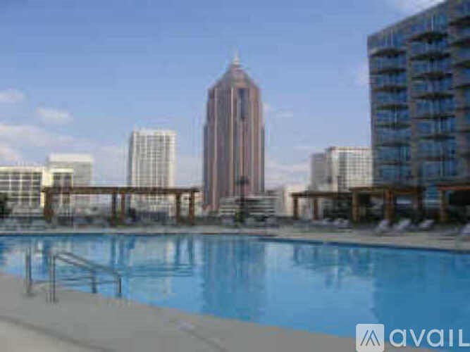A pool with a city skyline in the background.