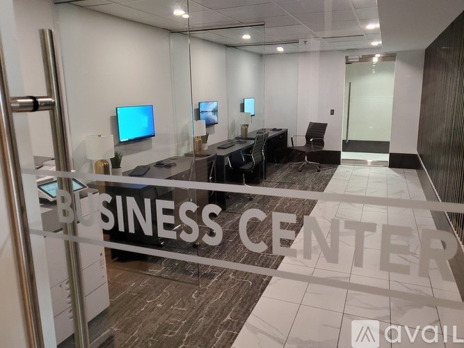 A business center with a glass wall and a sign that says "BUSINESS CENTER" on the floor.