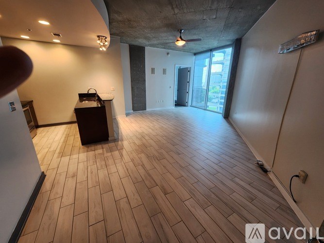 A room with wooden flooring and a ceiling fan.