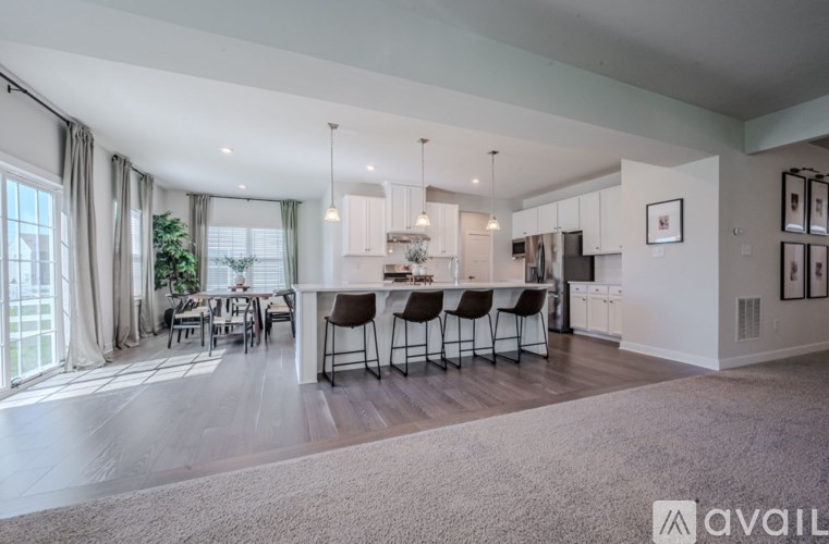A spacious kitchen and dining area with a large island in the middle.