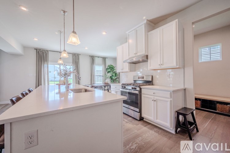 A modern kitchen with white cabinets and a large island.