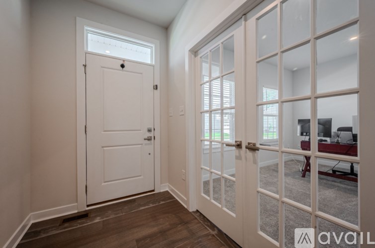 A white door with a glass window is open.
