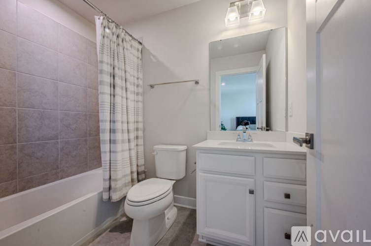 A bathroom with a toilet, sink, and bathtub.