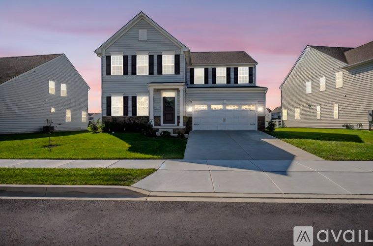 A house with a driveway in front of it.