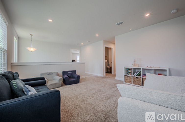 A living room with a dark blue couch and a light grey couch.